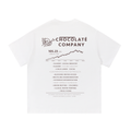 Back view of a white short-sleeve T-shirt featuring a faux chocolate company stock report with a rising price chart and a list referencing labor, environmental, and corporate controversies.