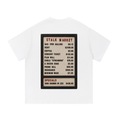Back view of a white short-sleeve T-shirt featuring a vintage changeable letter board listing consumer prices for gasoline, rent, coffee, concert tickets, wages, and other everyday goods beneath the heading "Stalk Market."